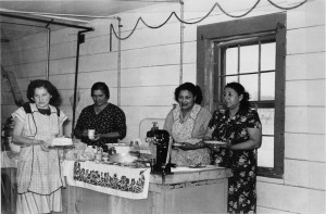 Members of the Fort Peck Friendly Homemakers Club prepare to serve food at a fund-raiser for a children’s Christmas party, circa 1948. Early clubs on the Fort Peck Indian Reservation were segregated by race, but the Extension Office worked to integrate clubs in the 1960s.