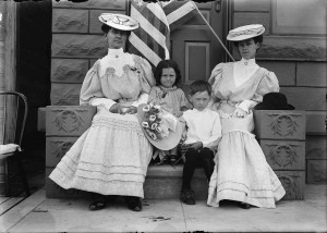 Cameron photographed (left to right) Mrs.F. P. Reiley and Mellisa, Dean, and Florence Fluss on July 4, 1906, at the First State Bank in Terry, Montana.Catalog #PAc 90-87.G006-004