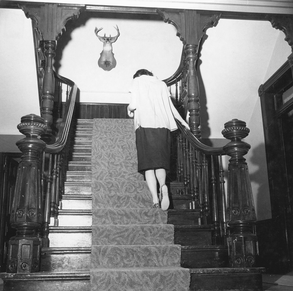 A woman, walking up the stairs at the Florence Crittenton home, circa 1945