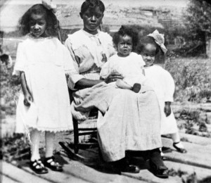 As an adult, Alma Smith Jacobs--posed here (far right) with her mother and sisters at Spring Creek near Lewistown, ca.1920--made numerous contributions to Montana as a civil rights activist. She is most often remembered, however, for her work as a librarian. MHS Photo Archives PAc 96-25.1