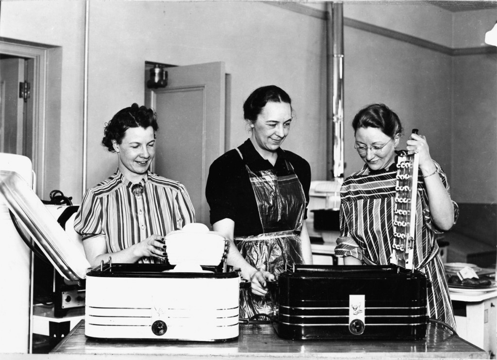 As representatives of the Extension Service, county Home Demonstration agents reached rural women with workshops, bulletins and circulars, radio and television broadcasts, and, most popularly, at meetings held in club members’ homes. Here, circa 1945, agents Lois Knowlton Stephens, Frances Smith Patten, and Lillian Stone Mikkleson demonstrate electric roasters, one of many electrical appliances which became more commonplace in rural homes after World War II.
