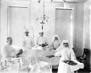Beginning with the arrival of the Sisters of Charity of Leavenworth in 1869, women religious played a vital role in providing health care for Montanans. Here Sister Camille (near instrument stand) and Sister St. Charles assist Doctors (left to right) Thomas H. Pleasants, Fred Attix, and Joseph Brice with a 1909 surgery at St. Joseph’s Hospital in Lewistown. MHS Photo Archives 949-002