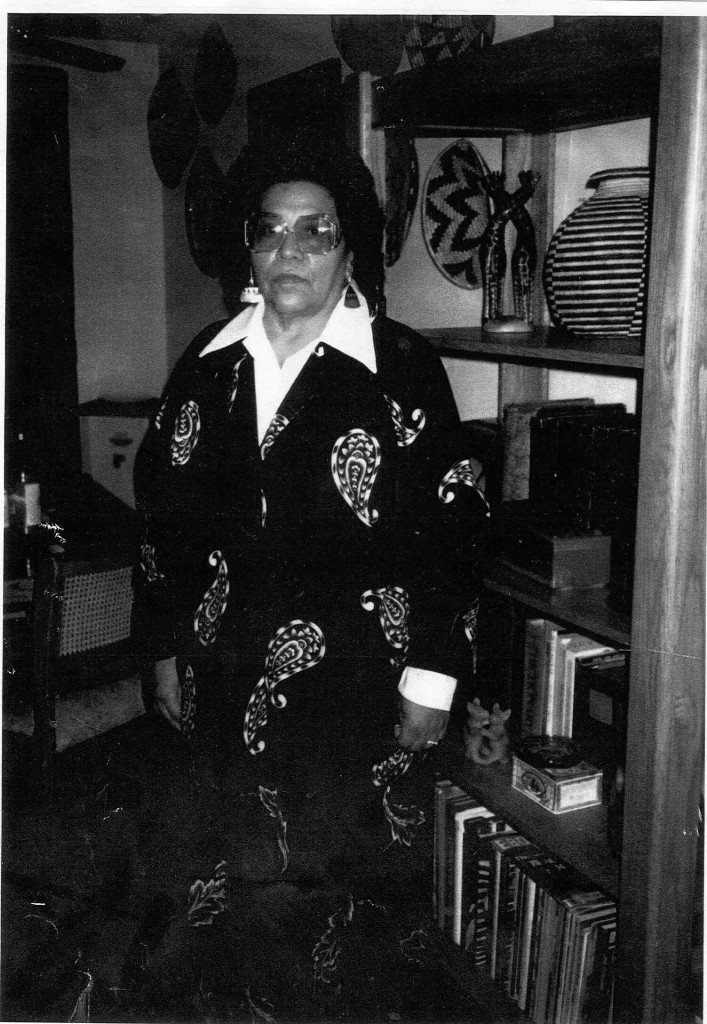 A middle-aged Lula Martinez, posed in front of a bookshelf.