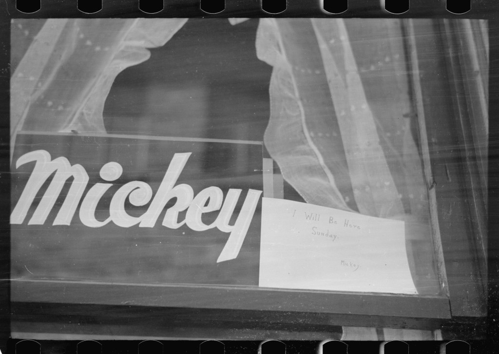 Window with curtains, sign that reads "Mickey," and a handwritten note reading "I will be here Sunday."