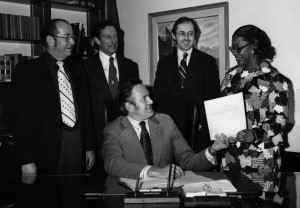 An active member of the Montana Women’s Political Caucus Geraldine Travis was elected to the Montana House of Representatives from House District 43 in 1974. She is pictured here with Governor Thomas Judge (seated) and other politicians as Judge signs her first bill into law. Photo Courtesy of Geraldine Travis 