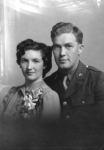 Marriage portrait: Lucille Paddock, wearing a corsage with her new husband, John, wearing his military uniform.
